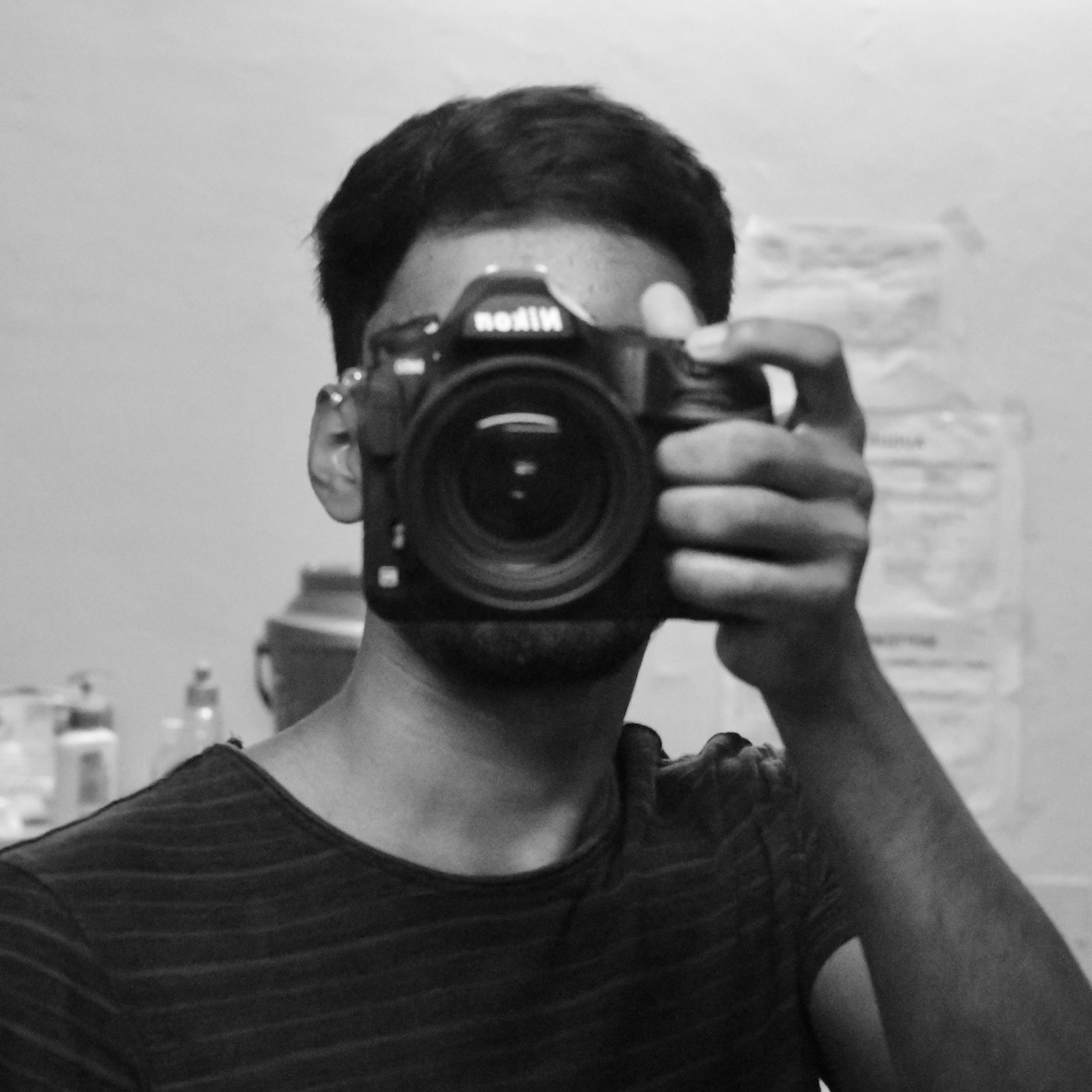 Black-and-white portrait of Navneet Singh holding a camera